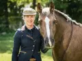 Lächelnde Reiterin mit Pferd, bereit für Working Equitation Einsteiger.